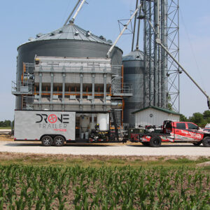 agricultural drone trailer in front of a silo