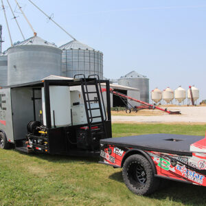 agricultural drone trailer in front of silos on farm
